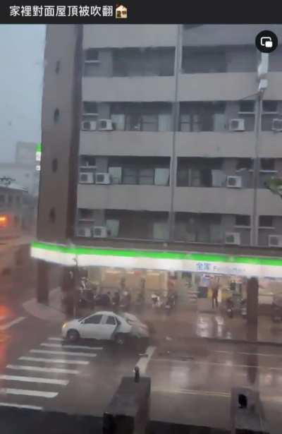 In Taiwan, Typhoon Gaemi rips a roof off, sends wall crashing onto car below