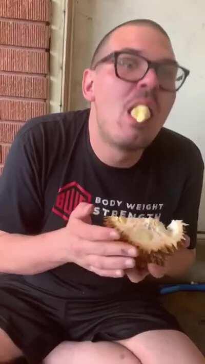 Guy tries durian for the first time.