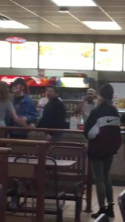 Drunk girl tries to throw hands with a cop standing behind her in line