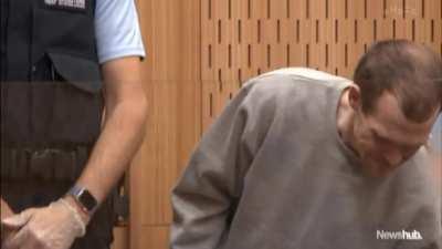 An uncommon clip of Brenton Tarrant smiling in court