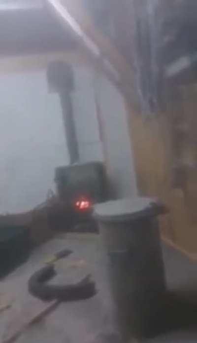 Putting an aerosol can in a wooden stove