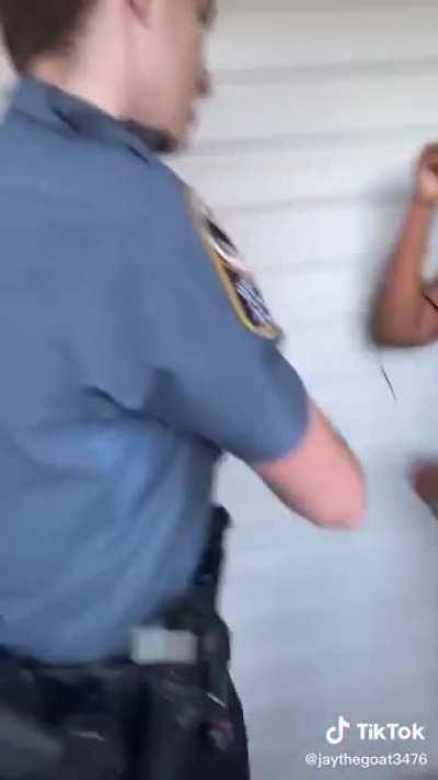 Cop rips a woman off of her porch after she tells him that nobody called the police