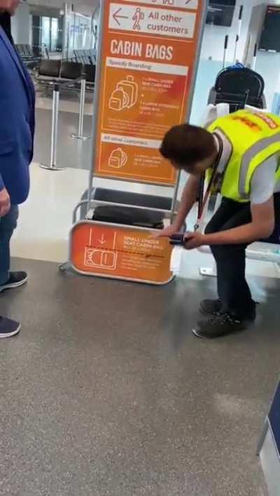 A gentleman demonstrates carryon policy compliance