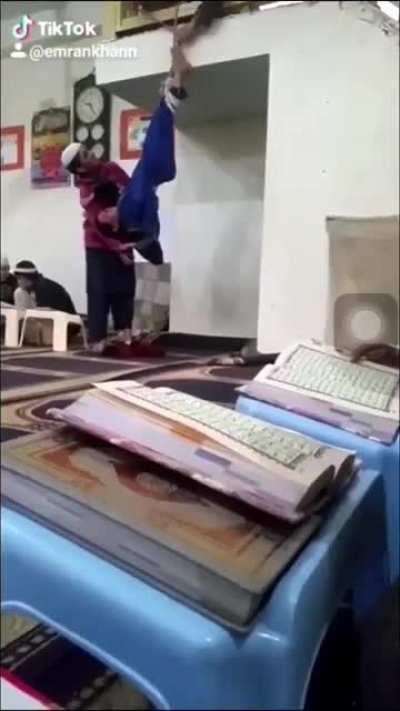 VIDEO Boy hung up by his feet in mosque