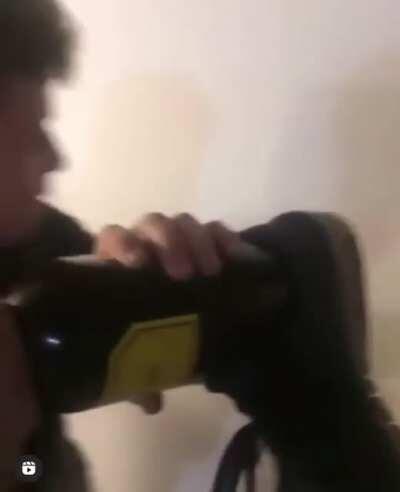 Smashing a bottle while holding it