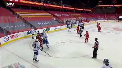 Muzzin flips a puck at Tkachuk after the game ends