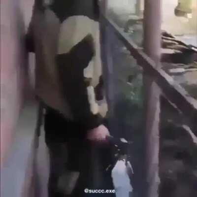 Guy touches exposed electric current to metal fence (loud)