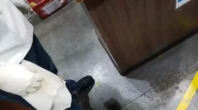 Woman refuses to let man exit grocery store