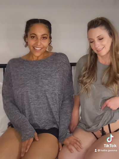 Two beautiful women kiss