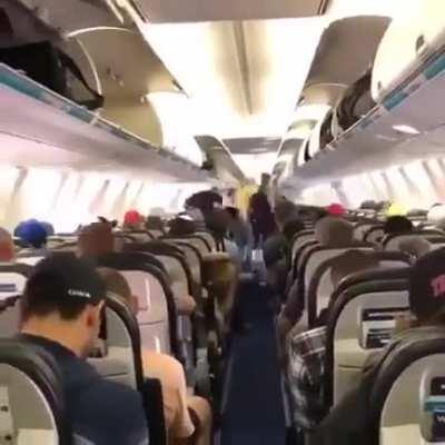 Passengers on Canadian airline waiting calmly to exit