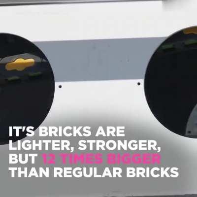 Brick laying robot constructs wall from CAD model. Automatically cuts, cements, and places bricks.