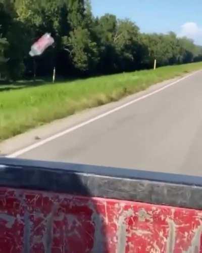 Bottle flying behind car