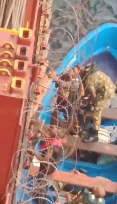 holding a camera to binoculars is not easy… while videoing pirates.