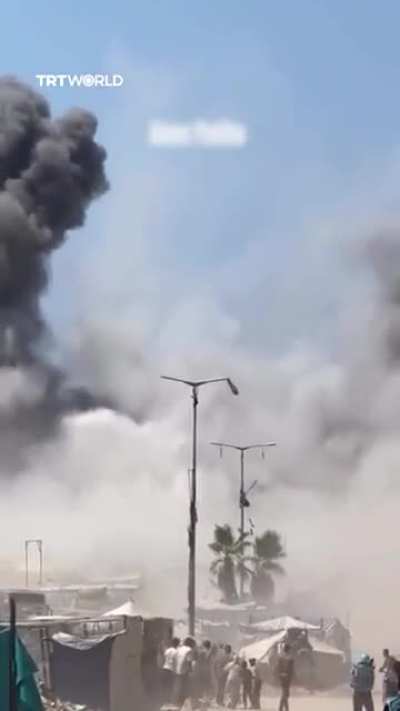 Israeli strikes demolish a residential high rise building with displaced people directly beneath