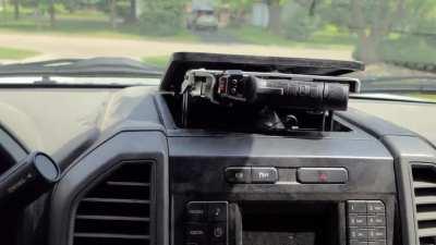 Pop out gun storage for work truck. Pull the nob and it unlatches the hinge and a gas ram pushes it up and out.