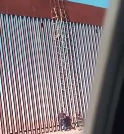 people climbing the wall