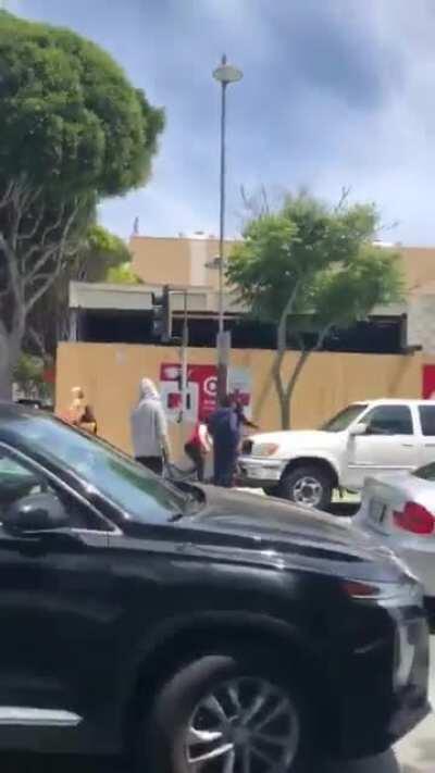 Elderly man beat up by a mob of rioters after trying to help woman being robbed by them in Santa Monica.