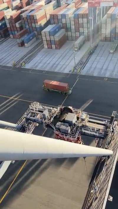 crane operator shows backup of shipping containers in a terminal