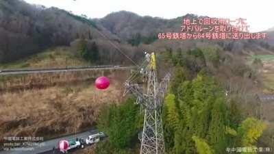 Company in Japan used balloons to decommission an old power line without blocking highway traffic