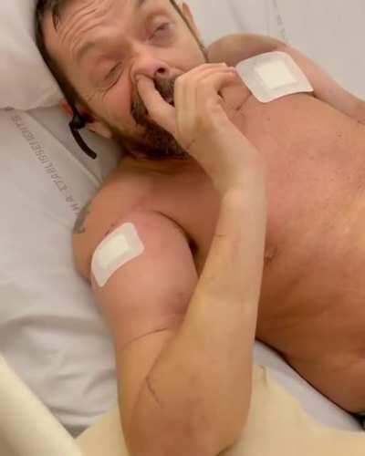 The world's first double arm transplant recipient celebrates by picking his nose.