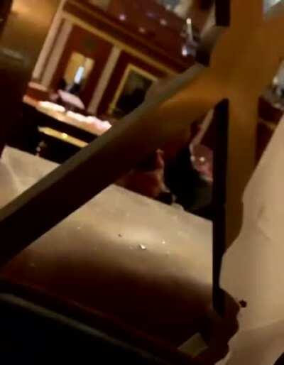 Police officers inside the main chambers in Capitol Hill hold the Trump terrorists on gun point.