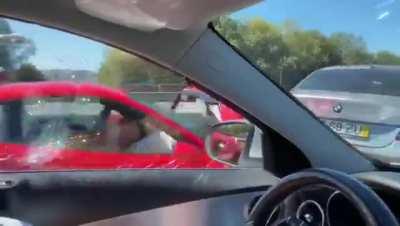 A Ferrari kissing a Bimmer