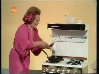 A delicious mincemeat omelette by Fanny Cradock. She wants you to see it's still wet in the middle.
