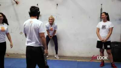 Ashley Roberts verbal and kick's a male Krav Maga practitioner in the balls (he's wearing a cup) in NBC Connecticut's 1st Look: Work off that Turkey (2006)