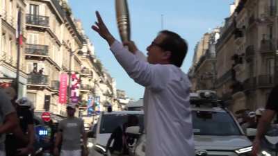 Jackie Chan carrying the Paralympic torch through Paris