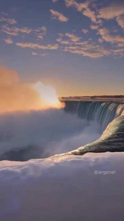 The first rays of dawn over the raging Niagara Falls.