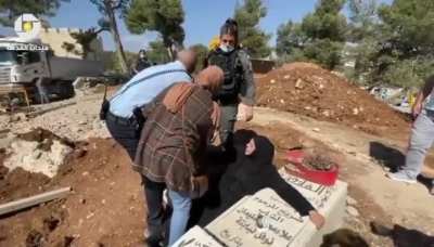 screaming “Leave me to die with him”, Israeli forces attacking and forcibly pulling a Palestinian mother from her son's grave as she tried to prevent them from destroying the grave 