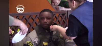 Mexican restaurant workers rendering aid to pepper sprayed cops.  Or just Americans being Americans.