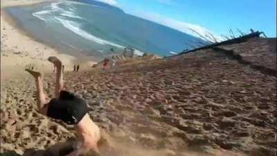Camera man manages to keep the gymnast in frame while running downhill.