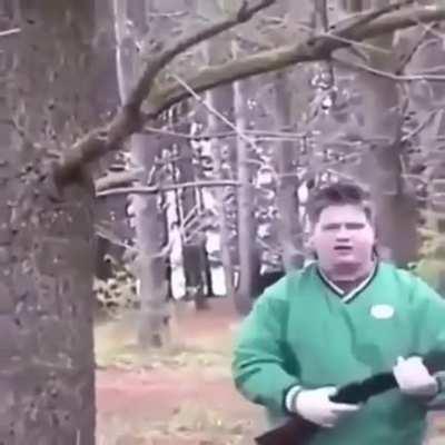 Kid tries to climb a tree with a shotgun
