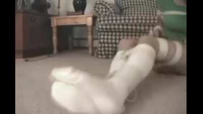 Struggling on the floor in kneesocks