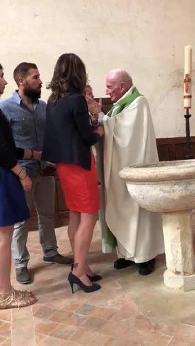 Priest slaps baptized child for crying