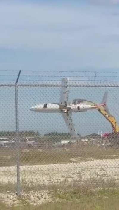 Florida Man flies Learjet with Excavator like a toy Plane lmao