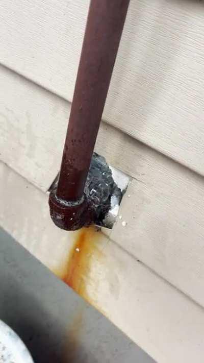 Gas leak in residential house, installed with now sleeve no paint to protect metal pipe.