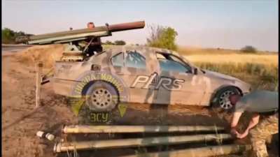 Ukraine’s 137th Territorial Defense Battalion uses a homemade rocket launcher on a BMW sedan to target Russian forces.