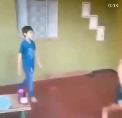 Two boys shove each other..