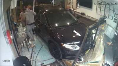 Car crashes into pizza shop