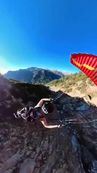 Paragliding down a valley, while 360 spinning