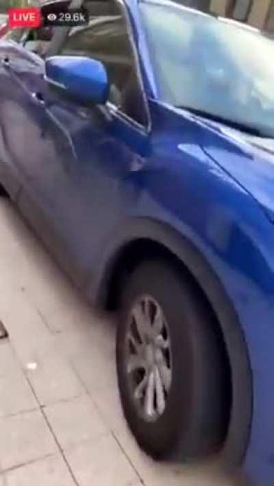 Lady stops her car in the middle of the street in order to steal some sneakers