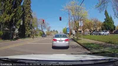 Driver in silver Volkswagen stops at green light, then runs red