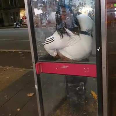 Classy British lady takes a dump in a phone booth.