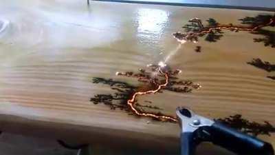 Electricity finding the path of least resistance on a piece of wood
