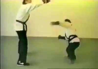 Man teaching an ape personal defense moves