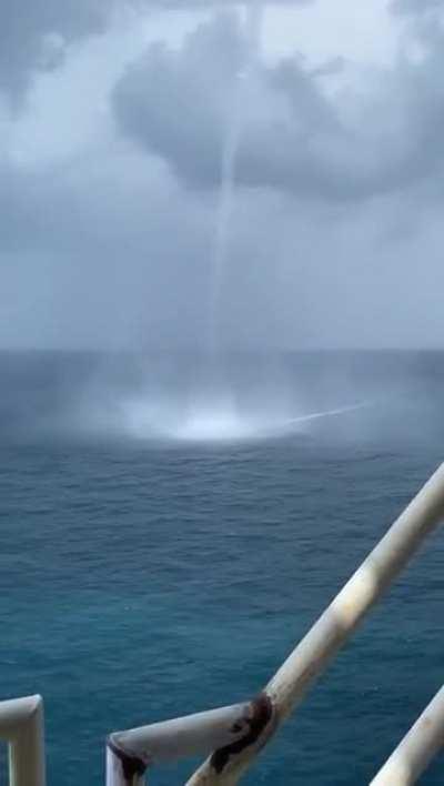 Three simultaneous waterspouts while out at sea. 