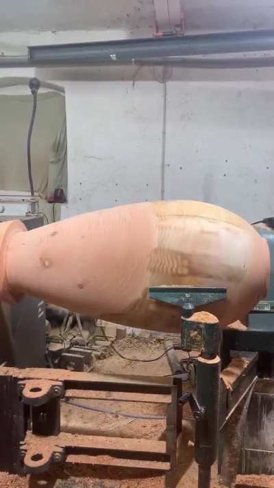 Wood turning a log into a textured vase