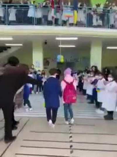 Ukrainian children being welcomed into their new school in Italy.